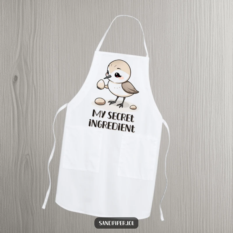 Funny Sandpiper Pebble Apron: A humorous kitchen apron depicting a sandpiper kindly offering a pebble, a great funny gift.