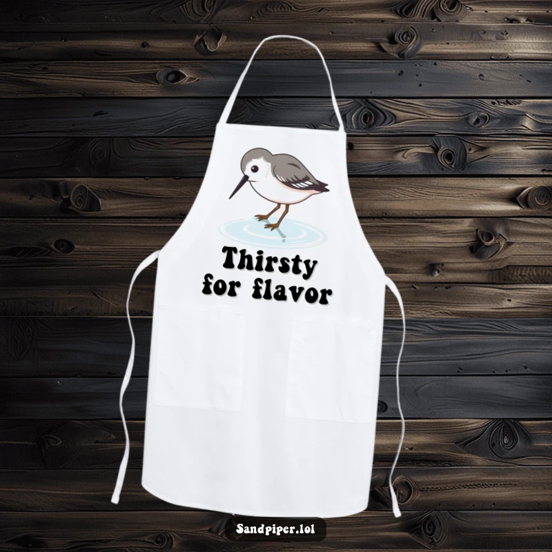 Funny Sandpiper Apron featuring a bird dipping its beak into water, a humorous kitchen accessory.
