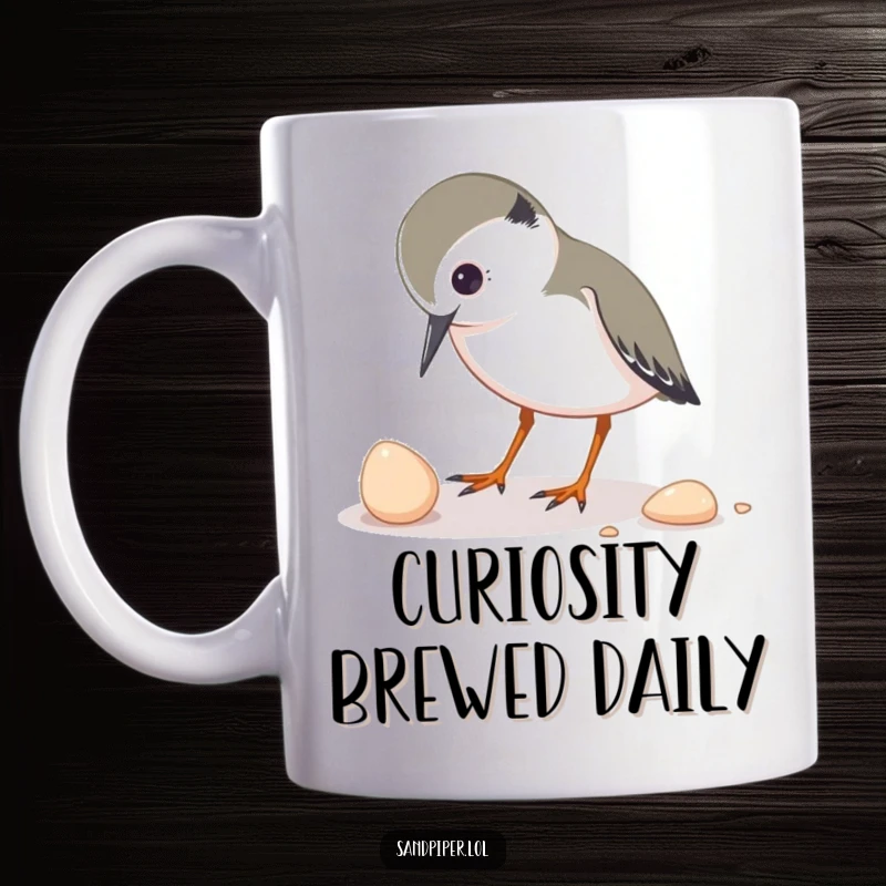 Funny mug featuring a sandpiper character inquisitively pecking at a small shell, showcasing a moment of gentle exploration.