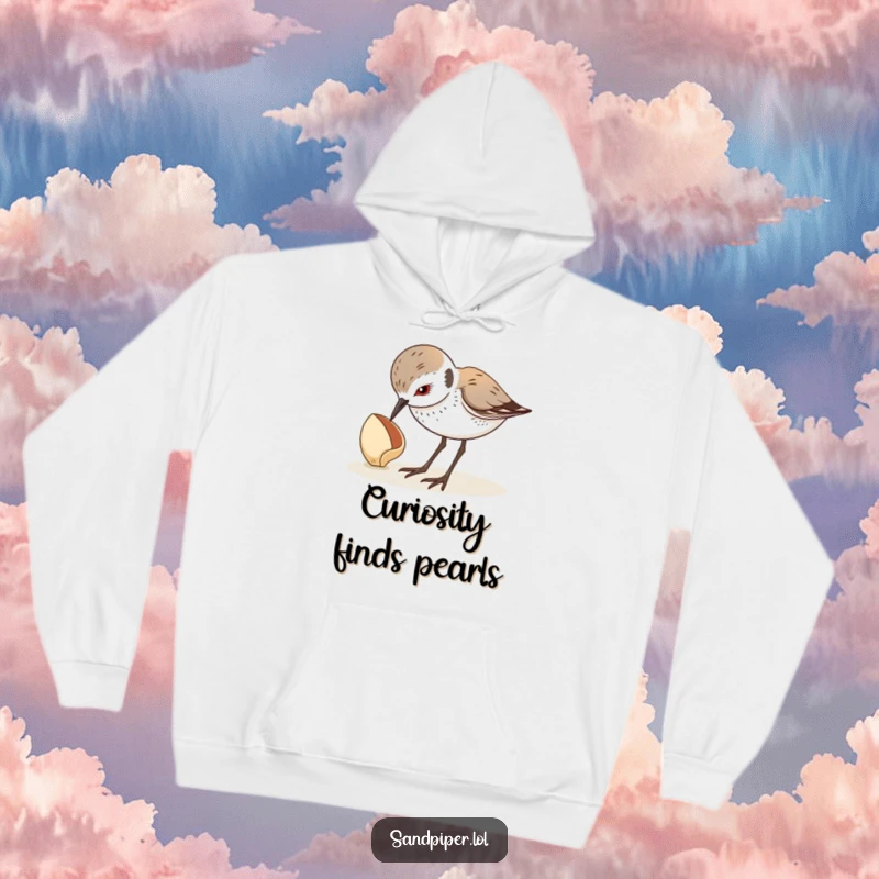 Funny hoodie with a sandpiper looking down curiously at a seashell, embodying beach exploration and wonder. A wonderful funny gift.