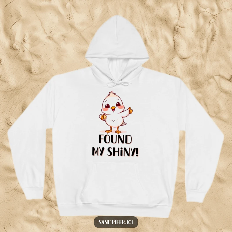 Funny Hoodie graphic of a smiling sandpiper bird character showing off a tiny found treasure, feeling delighted.