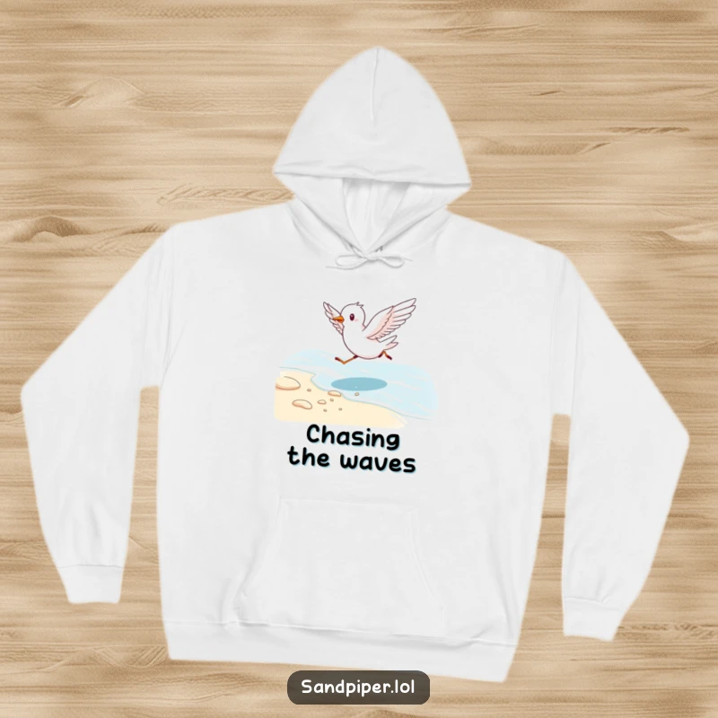 Funny hoodie depicting an energetic bird running along a shoreline with wings spread, capturing seaside joy and warmth.