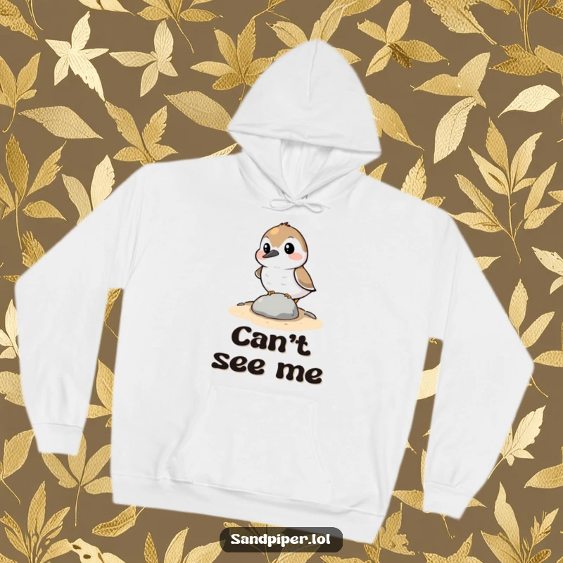 Funny Hoodie: A sandpiper character comically attempting to hide behind a small stone, offering cozy comfort and shy humor.