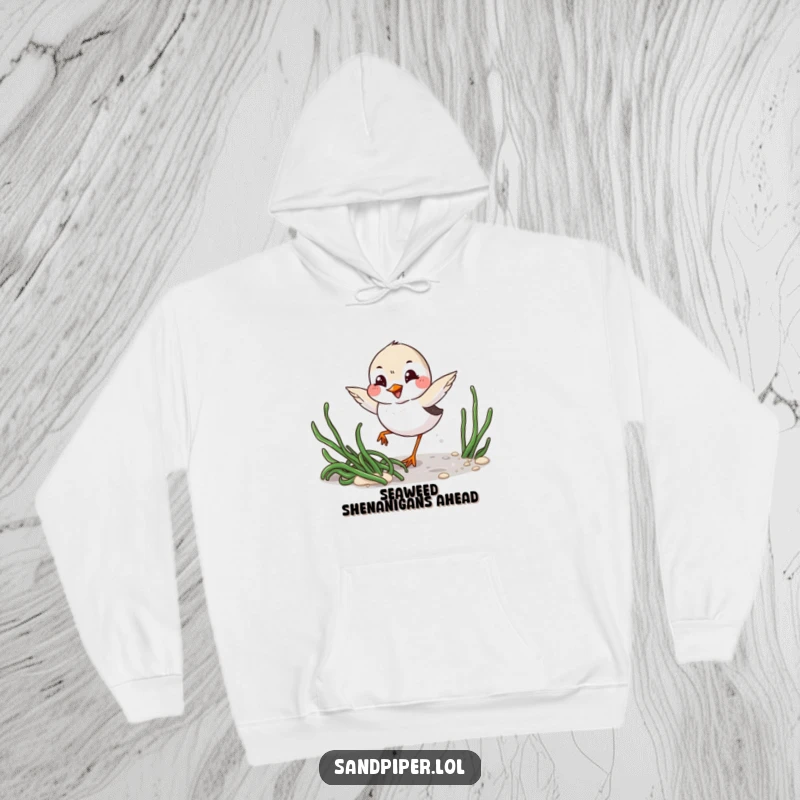 Funny Hoodie: Playful sandpiper with mischievous grin winks while darting around seaweed, offering cozy humor.
