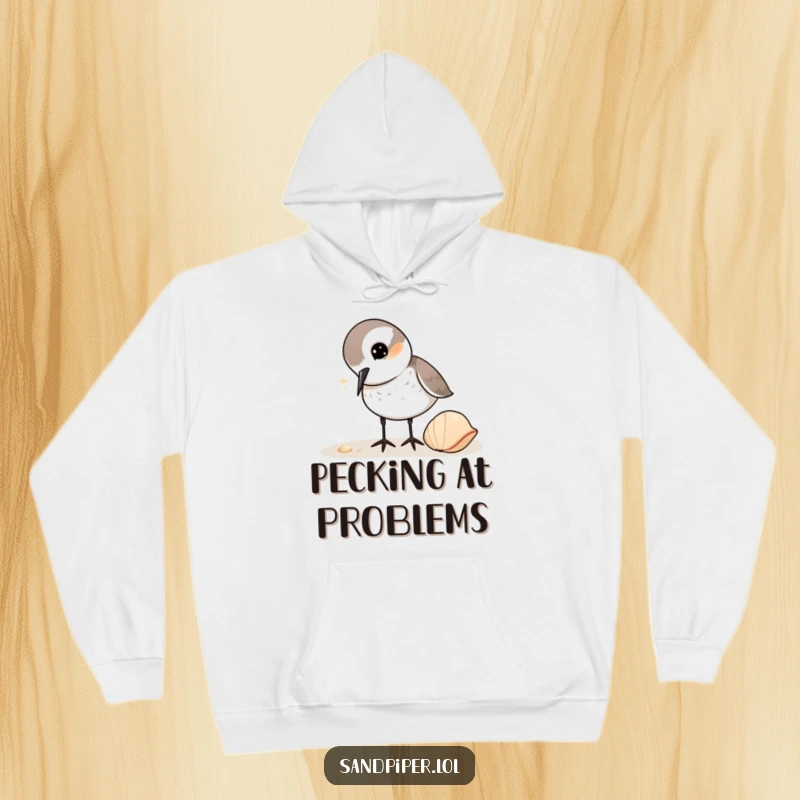 Funny Sandpiper Hoodie: A cute bird character curiously pecks at a shell, a warm and humorous design for outdoor lovers.