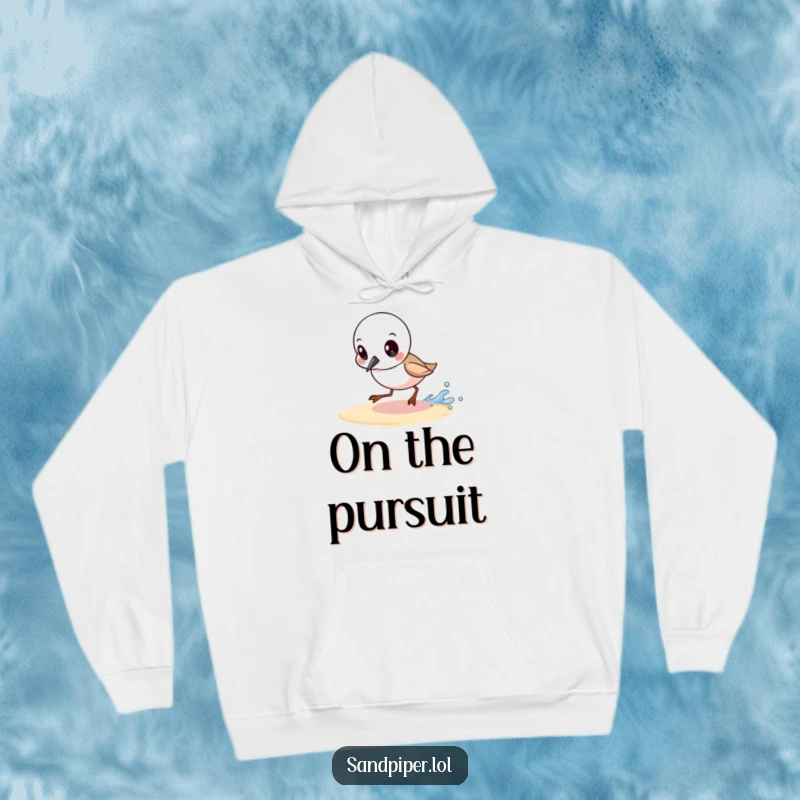 Funny hoodie depicting a determined sandpiper chasing a tiny wave, perfect for comfort and motivational style.