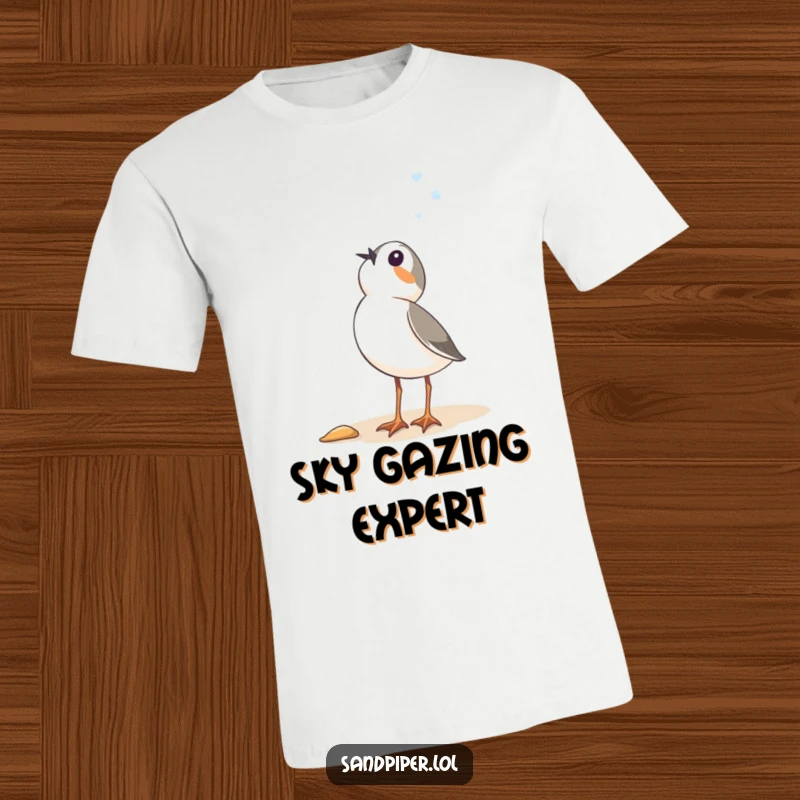 Funny Sandpiper T-Shirt: A comical bird standing on the beach, looking up at the sky with immense, humorous wonder.