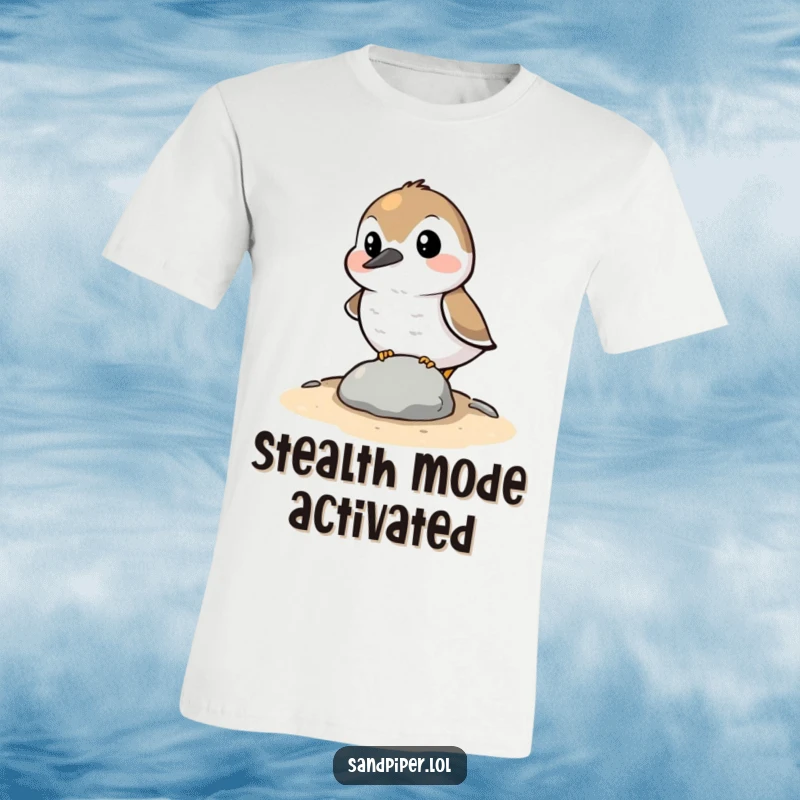 Funny T-Shirt: A sandpiper character comically attempting to hide behind a minuscule stone, showcasing humorous stealth and relatable shyness.