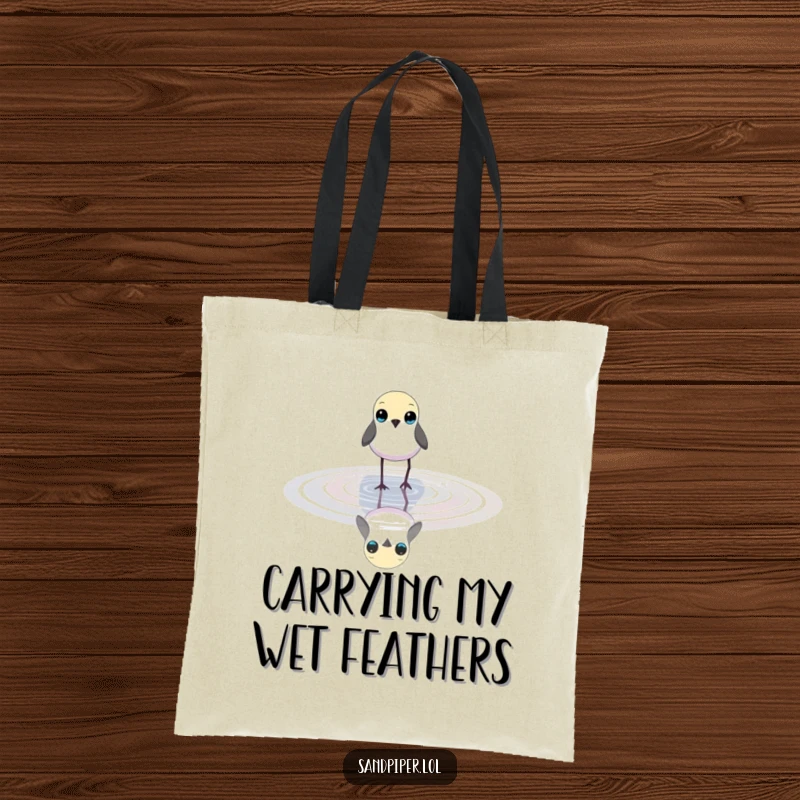 Funny tote bag featuring a small bird with bright eyes wading in shallow water, perfect for carrying nature essentials.