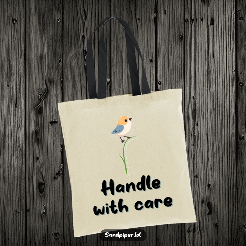 Funny tote bag depicting a bird shape in a precarious balancing act on a single, thin blade of grass.