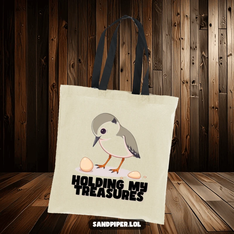 Funny tote bag featuring a sandpiper character inquisitively pecking at a small shell, perfect for carrying treasures and curiosity.